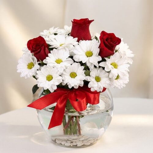 Arreglo floral Antonietta con rosas rojas, margaritas blancas y lazo rojo en jarrón de cristal, ideal para regalar en ocasion